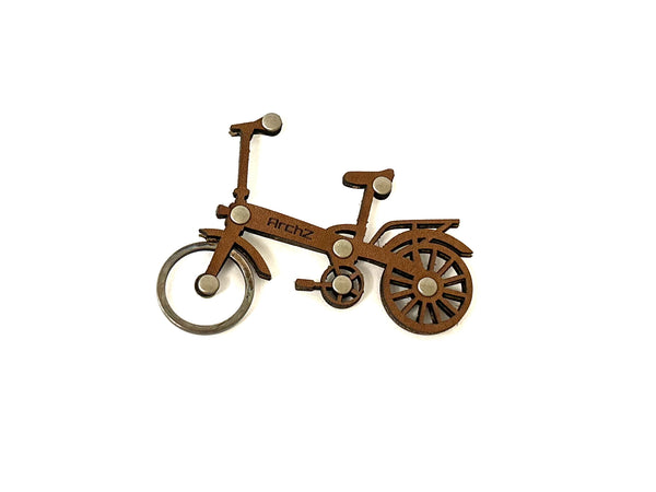 Brown leather bicycle-shaped keychain on a white background